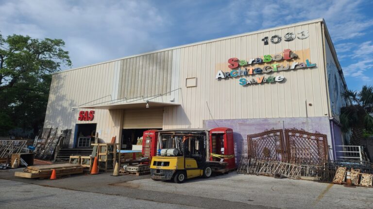 Warehouse building with items out front.