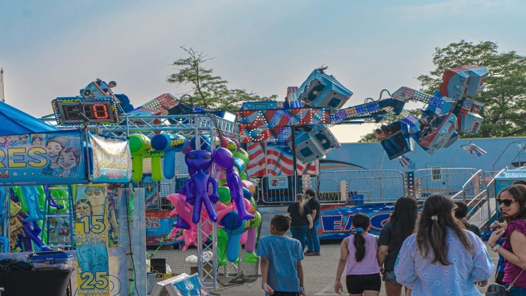 people walking with carnival rides