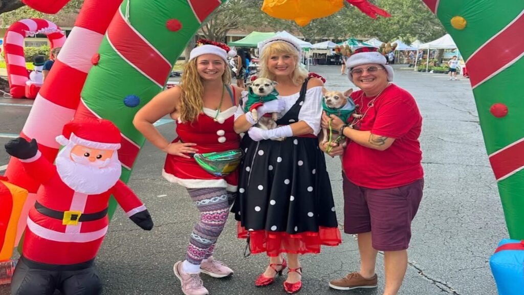 three people posing in front of xmas decorations