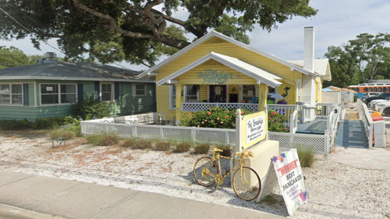 yellow bungalow beside another green bungalow