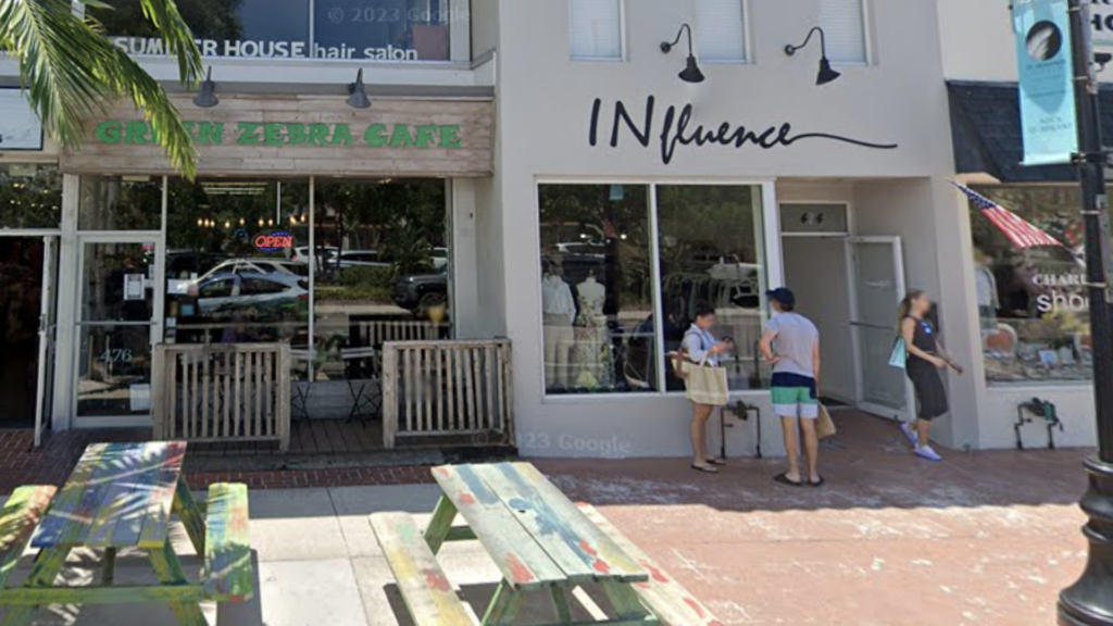 two picnic tables in front of store front