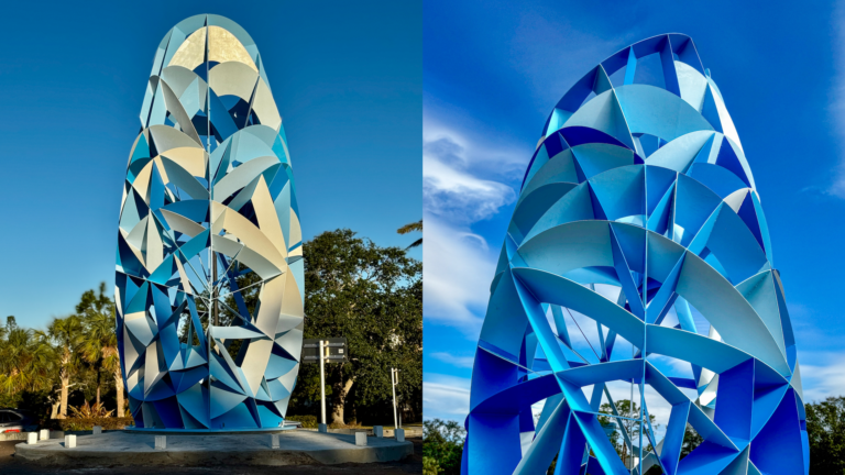 blue metal sculpture with blue sky background.