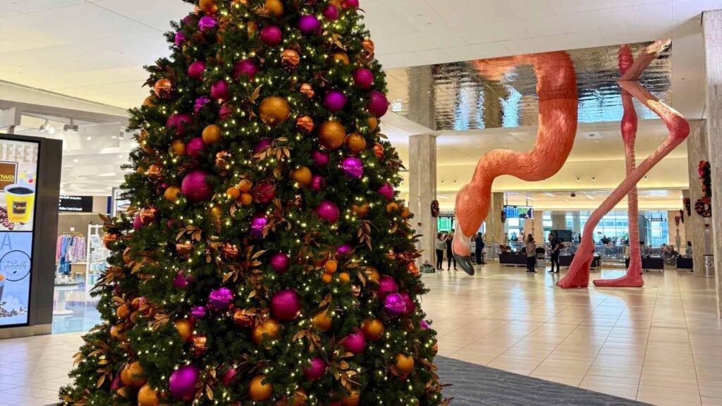 A Christmas tree with a flamingo in the background